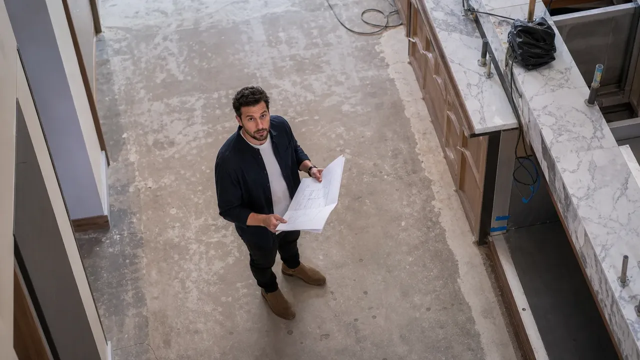 A build-out scene illustrating spending the debut once, shot from directly overhead in bright even light, with a member of the project team at work