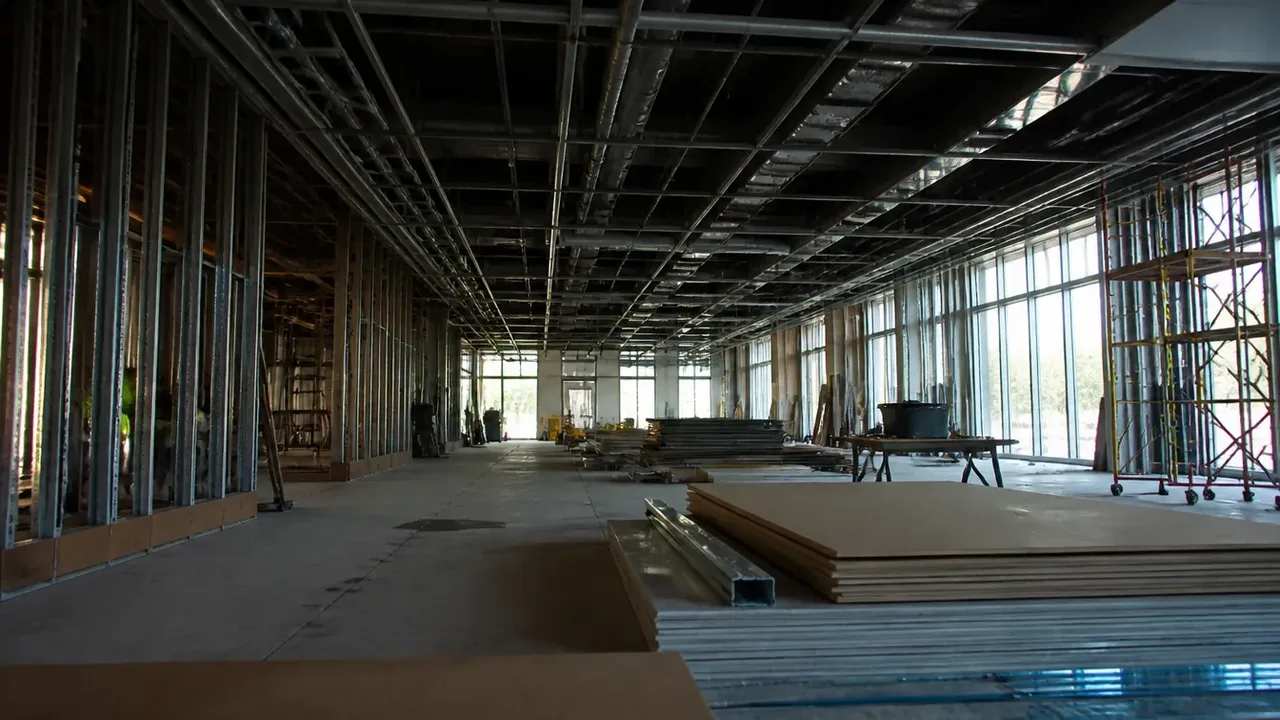 A build-out scene illustrating lie four: vintage and geography travel badly, shot low and wide to show the height of the room