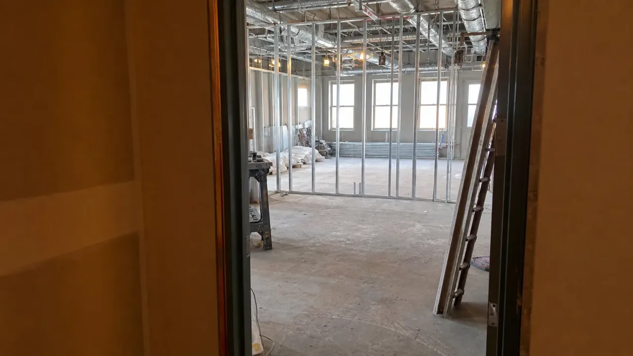 A view through a doorway into a hospitality build-out, illustrating how lead times ambush opening dates