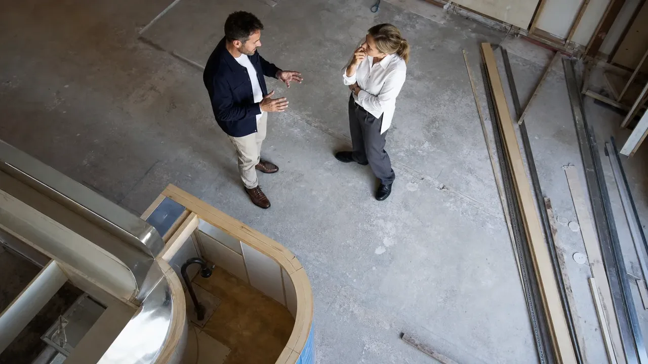 A build-out scene illustrating why the ambush works on smart people, shot from directly overhead in bright even light, with a member of the project team at work